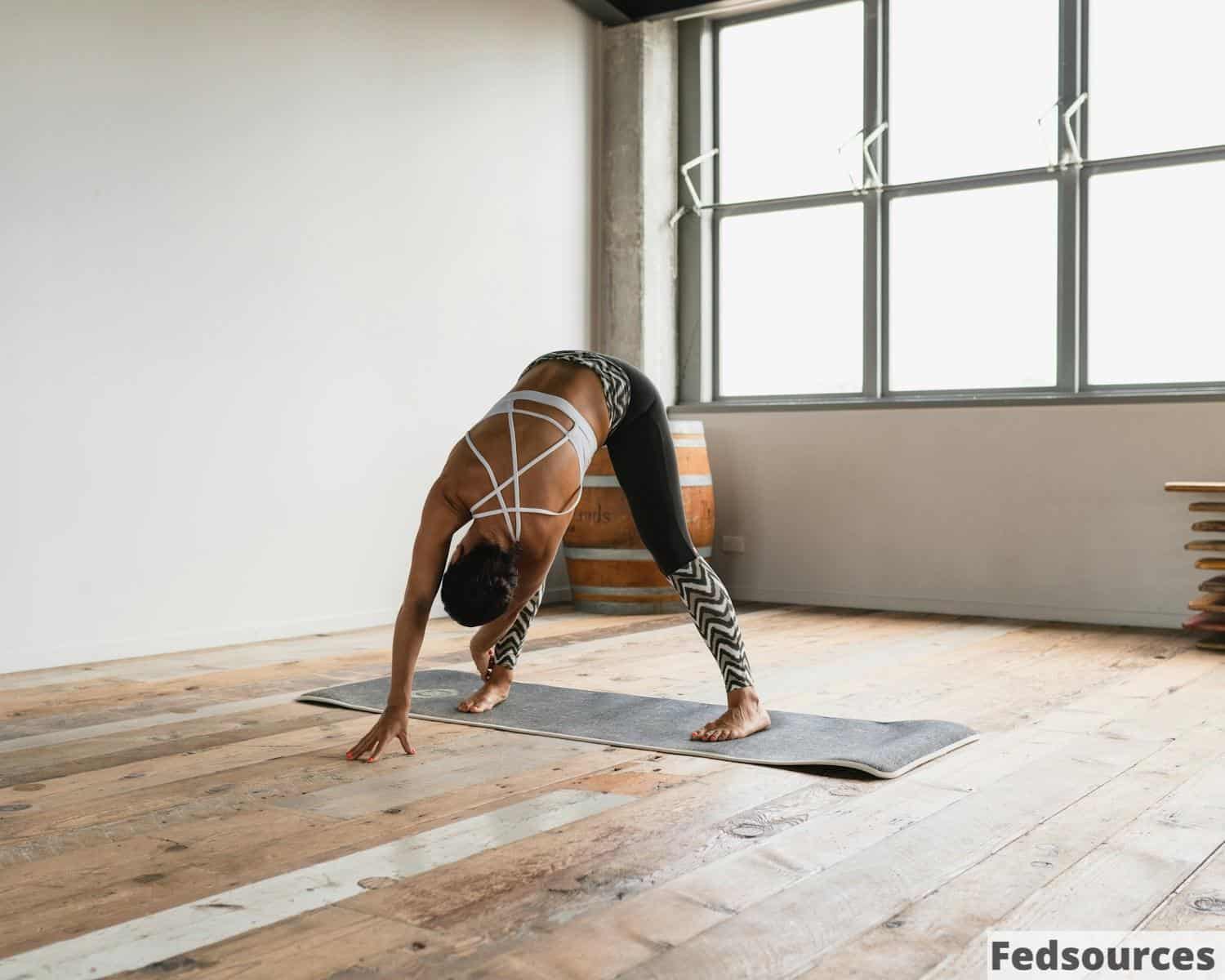 a person doing a handstand on a yoga mat