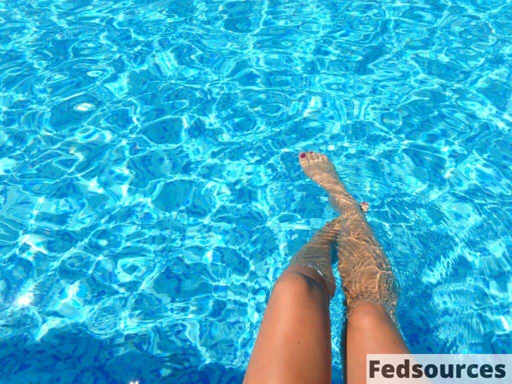 Person Feet Dipping on Pool
