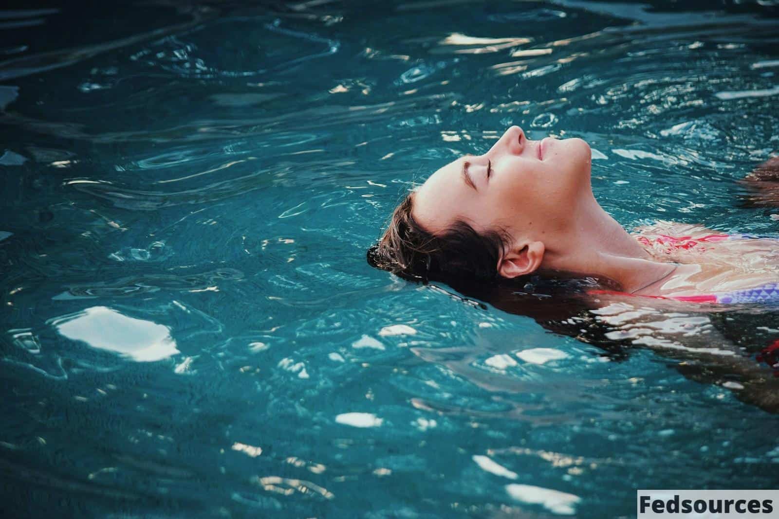woman floating on body of water