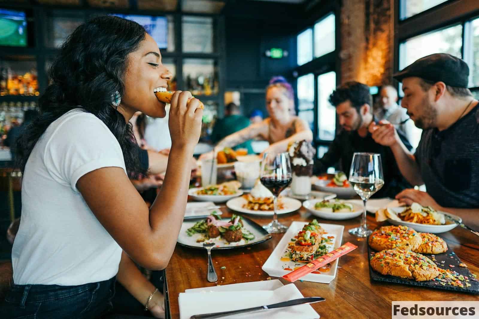 woman in white shirt eating