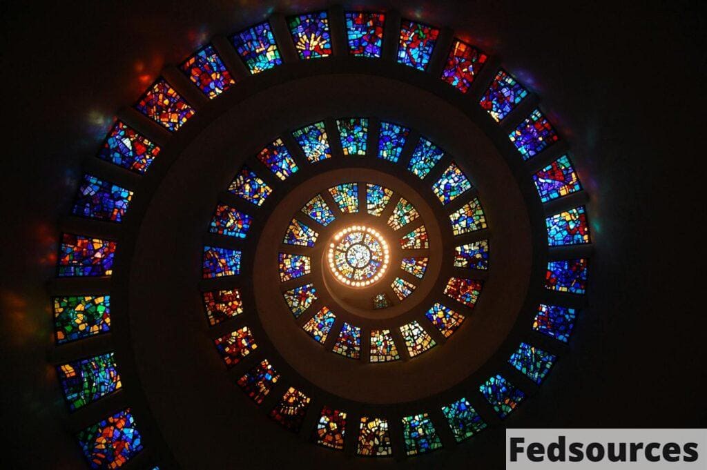 Captivating spiral stained glass art with vibrant colors forming a dramatic eye-catching pattern.